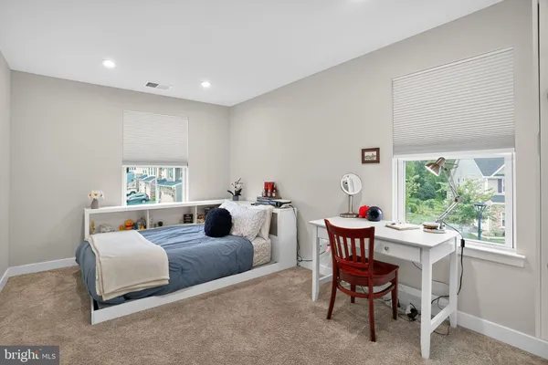 a bedroom with bed and a window