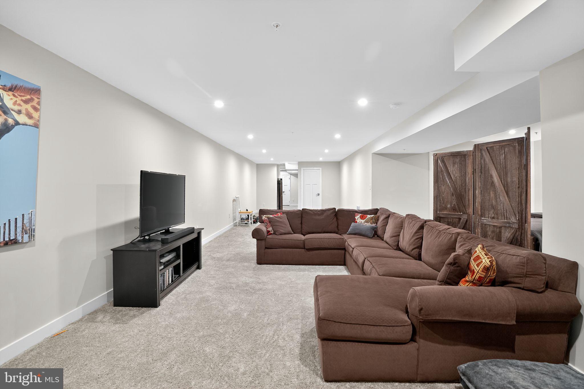 701 Cascade Way Kennett Square, PA 19348 - Photo 35 of 46 a living room with furniture and a flat screen tv