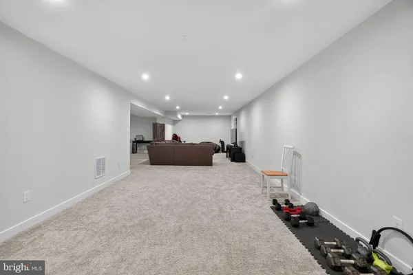 a spacious bedroom with a bed and a dresser