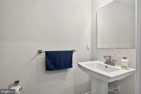 a bathroom with a toilet a sink and a mirror