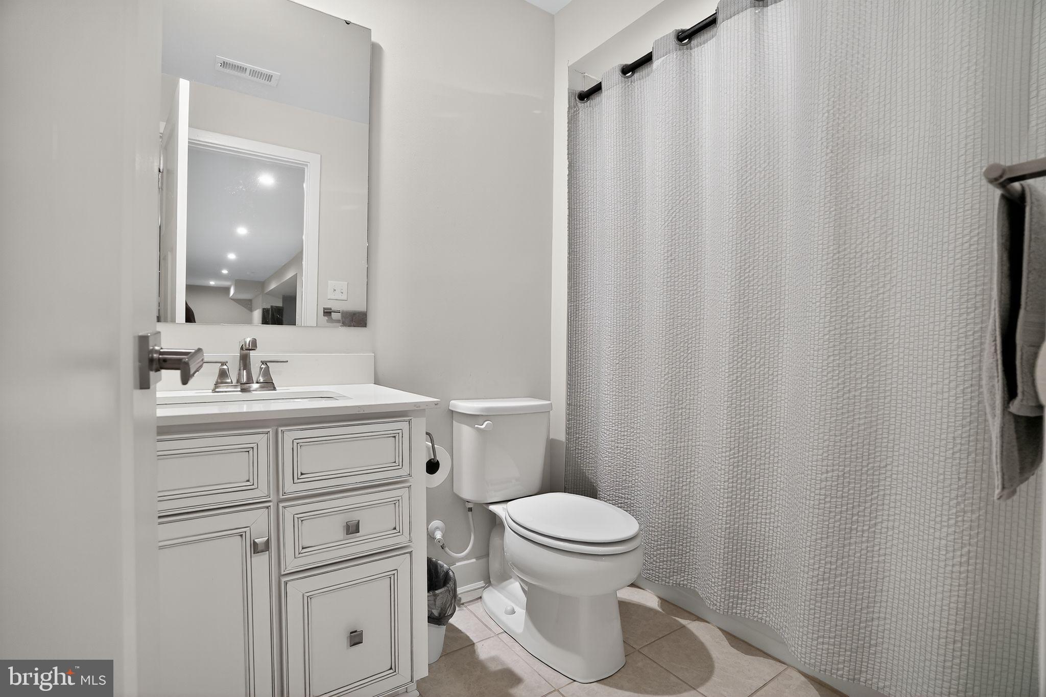 701 Cascade Way Kennett Square, PA 19348 - Photo 41 of 46 a bathroom with a toilet a sink and a mirror