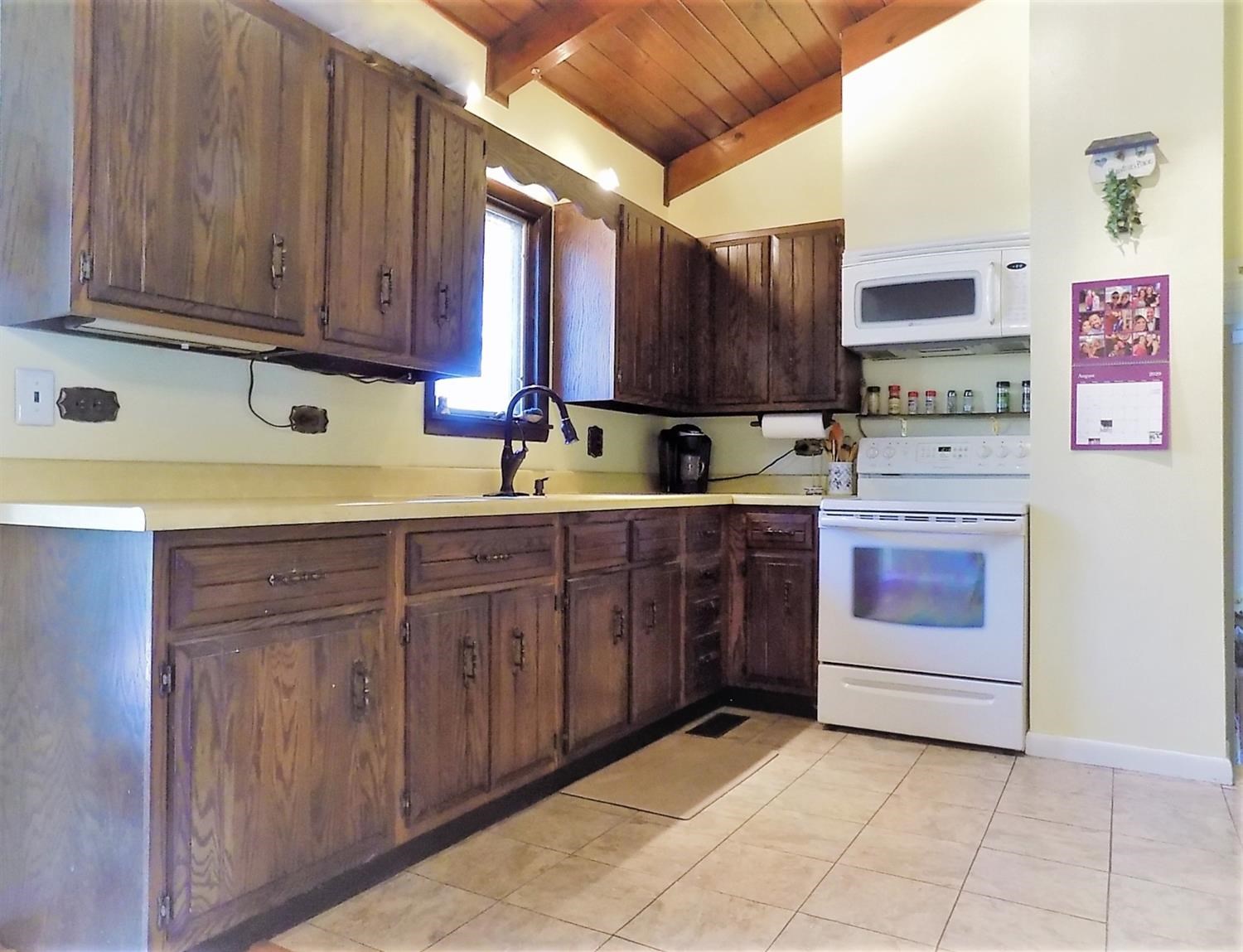 414 Wirth Road Griffith, IN 46319 - Photo 3 of 17 a kitchen with stainless steel appliances granite countertop a stove a sink and a microwave