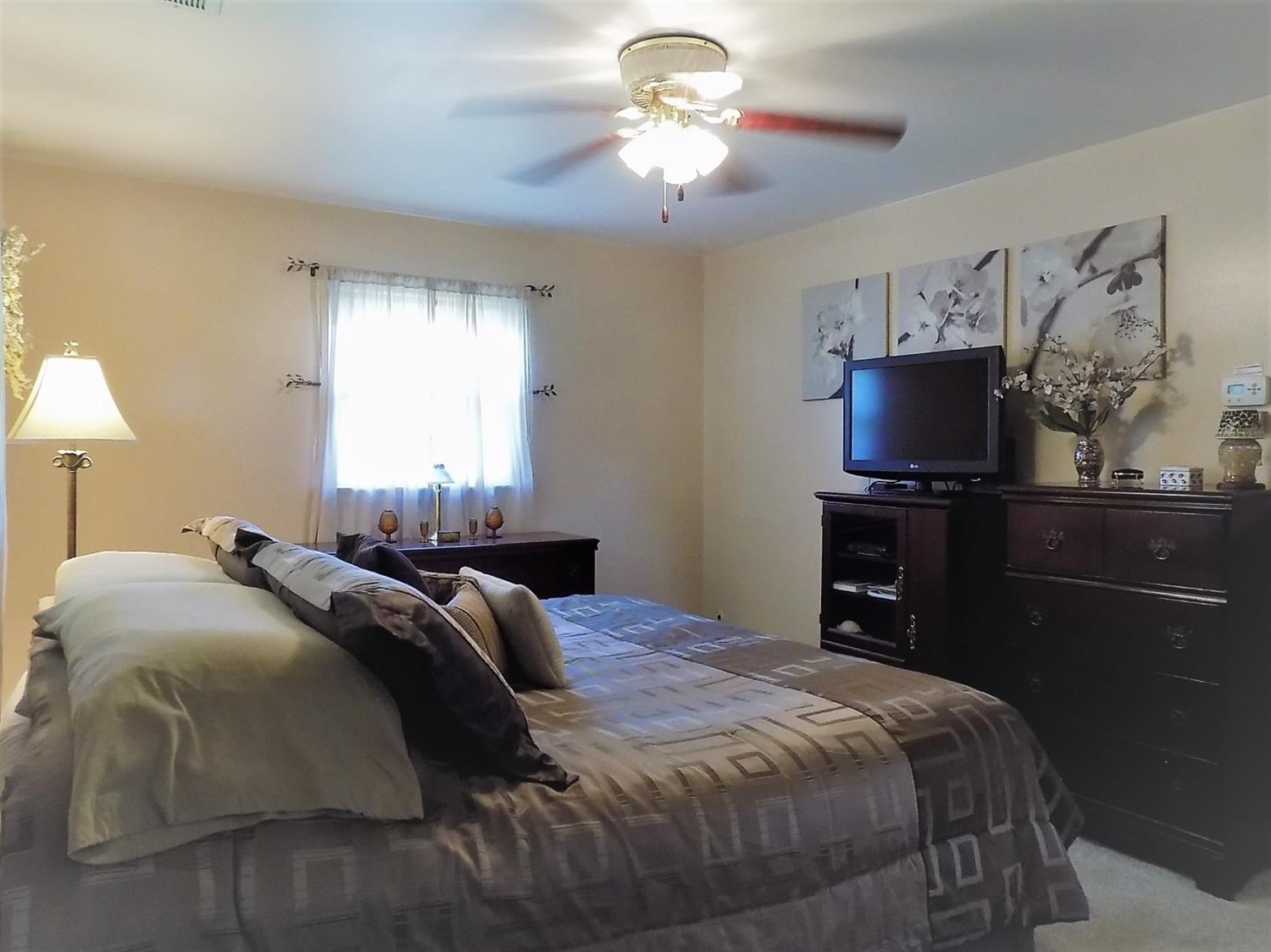 414 Wirth Road Griffith, IN 46319 - Photo 8 of 17 a bedroom with a bed and a chandelier