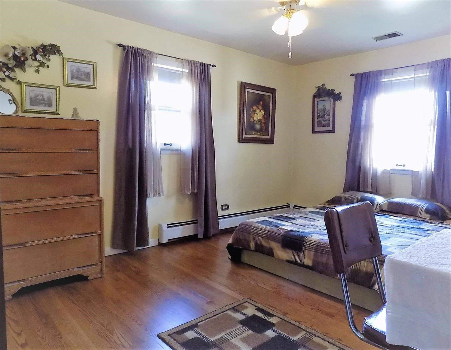 414 Wirth Road Griffith, IN 46319 - Photo 9 of 17 a bedroom with a bed and a chandelier