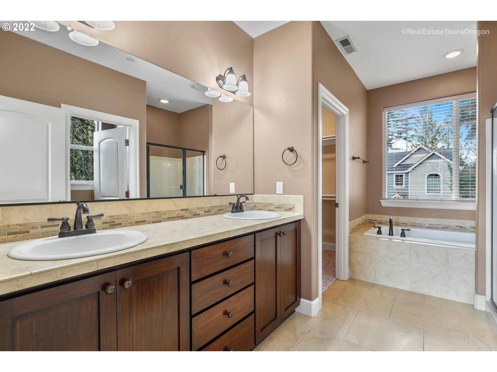 11510 Northwest Knightsview Lane Portland, OR 97229 - Photo 17 of 32 a bathroom with a tub sink double vanity and mirror