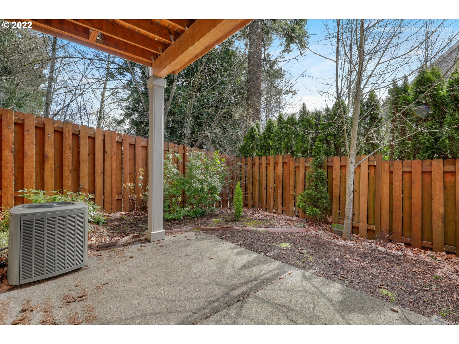 11510 Northwest Knightsview Lane Portland, OR 97229 - Photo 28 of 32 a backyard of a house with lawn chairs and wooden fence