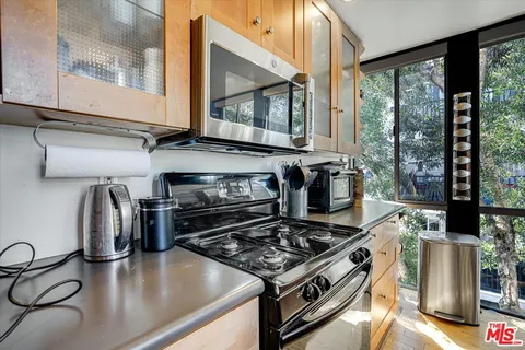 a view of a living room and floor to ceiling window or kitchen
