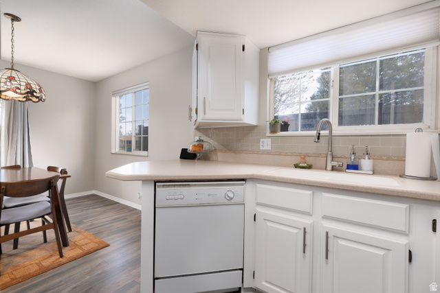 260 400 North, Unit 1 Orem, UT 84057 - Photo 16 of 17 Kitchen with light countertops, white cabinetry, white dishwasher, and tasteful backsplash