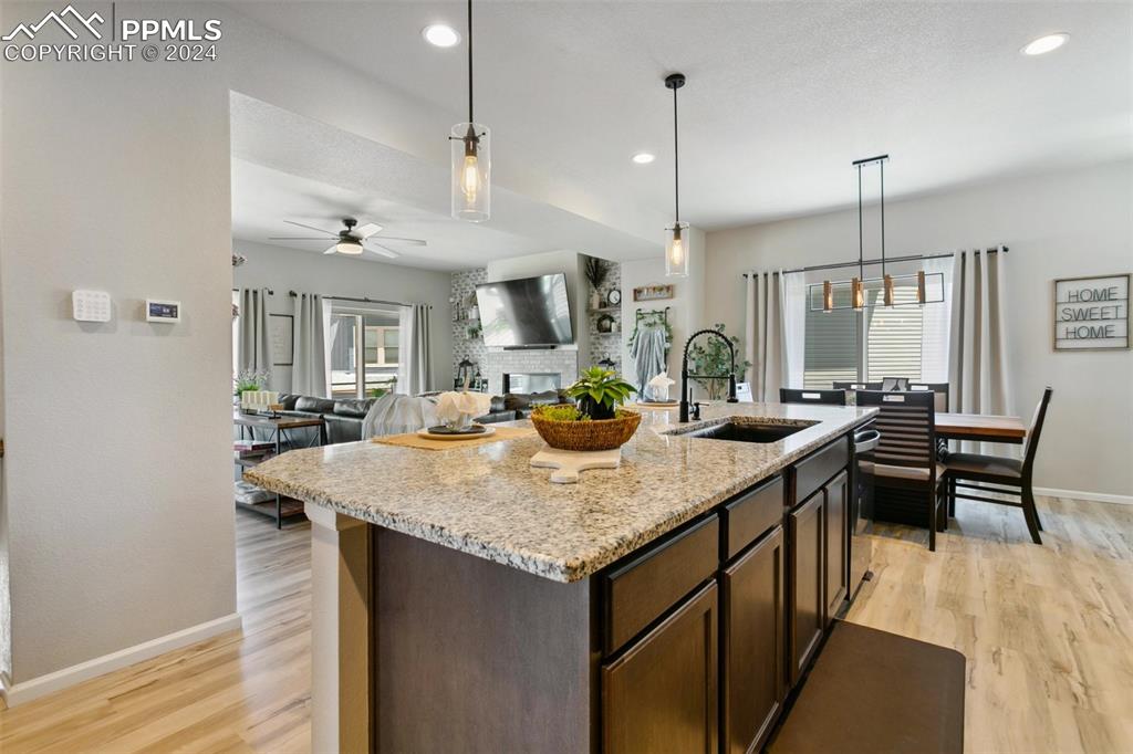 6149 Ashmore Road Colorado Springs, CO 80927 - Photo 15 of 41 a kitchen with center island table and chairs in it