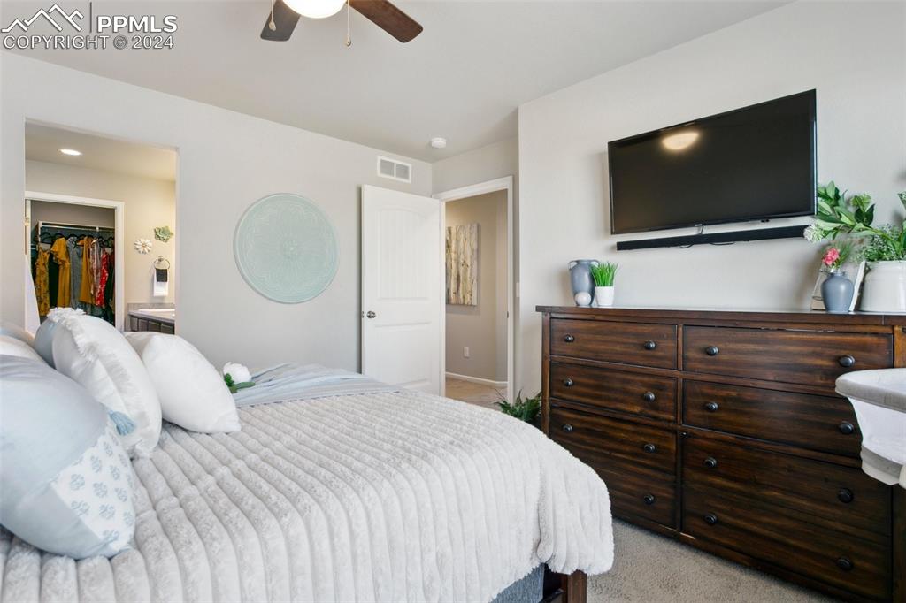 6149 Ashmore Road Colorado Springs, CO 80927 - Photo 25 of 41 a bedroom with a bed and a flat tv screen on dresser