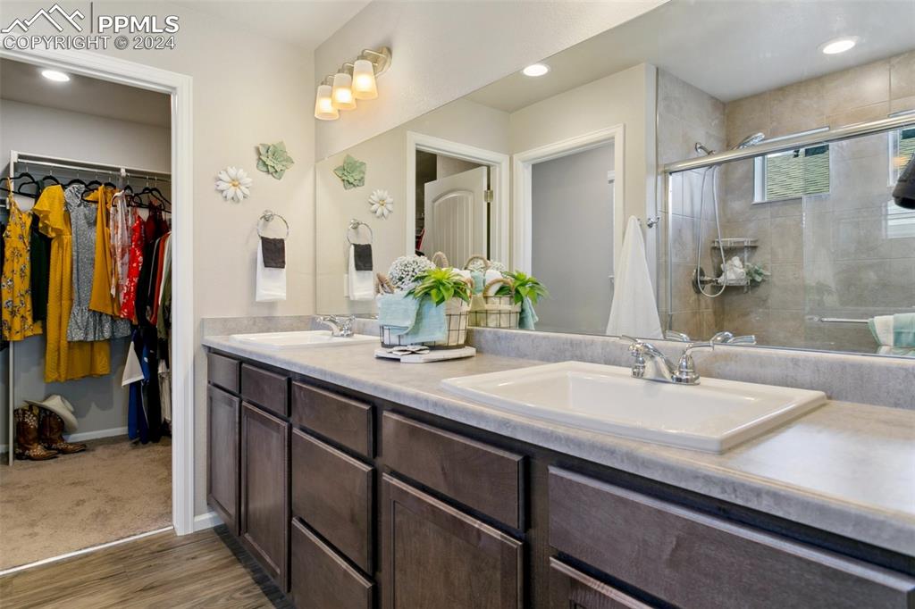 6149 Ashmore Road Colorado Springs, CO 80927 - Photo 26 of 41 a bathroom with a sink double vanity and a mirror