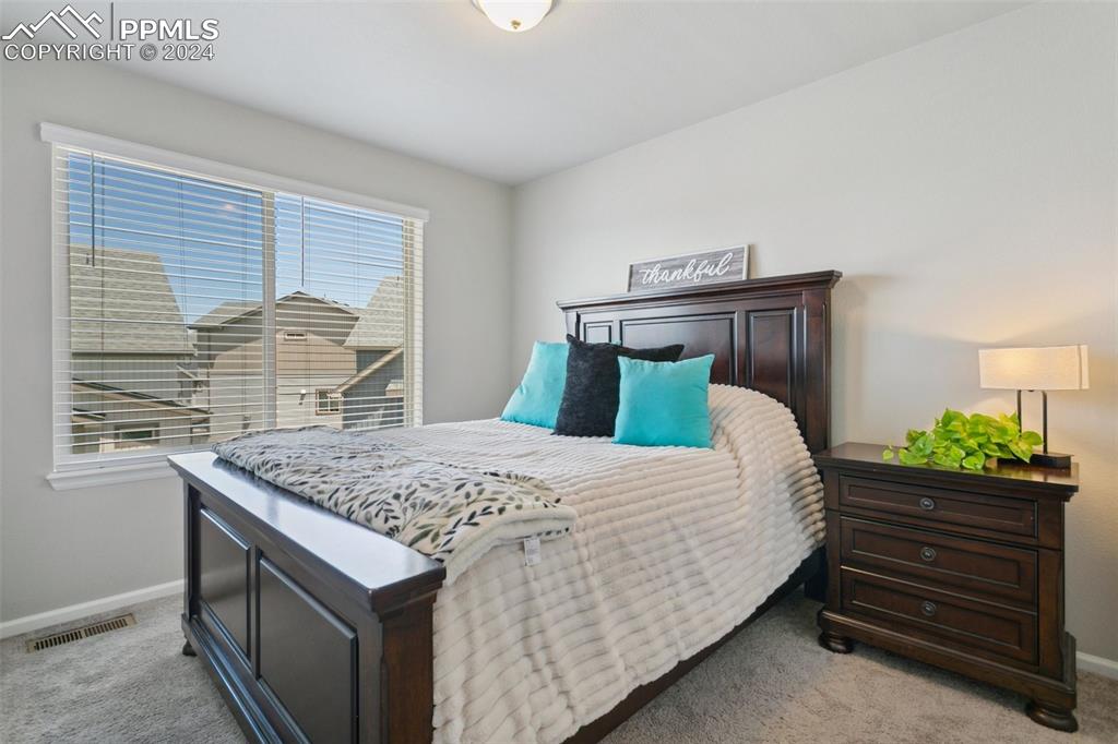 6149 Ashmore Road Colorado Springs, CO 80927 - Photo 31 of 41 a bedroom with a bed and a dresser