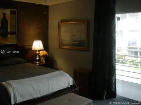 195 Fanshaw East, Unit 195 Boca Raton, FL 33434 - Photo 11 of 12 a bed sitting in a bedroom next to a window