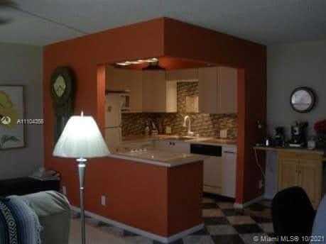 195 Fanshaw East, Unit 195 Boca Raton, FL 33434 - Photo 3 of 12 a kitchen with a sink cabinets and window