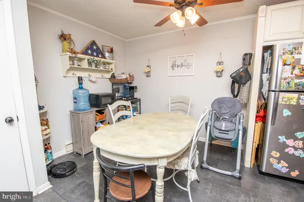 a dining room with furniture and wooden floor