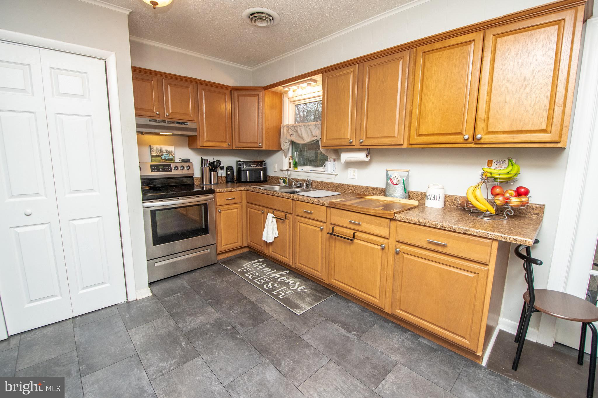 6790 Zion Church Road Salisbury, MD 21804 - Photo 6 of 13 a kitchen with stainless steel appliances granite countertop a stove sink and cabinets