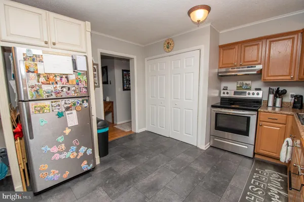 a kitchen with stainless steel appliances granite countertop a refrigerator and cabinets