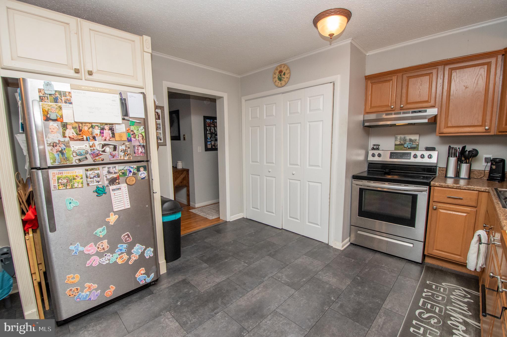 6790 Zion Church Road Salisbury, MD 21804 - Photo 7 of 13 a kitchen with stainless steel appliances granite countertop a refrigerator and cabinets