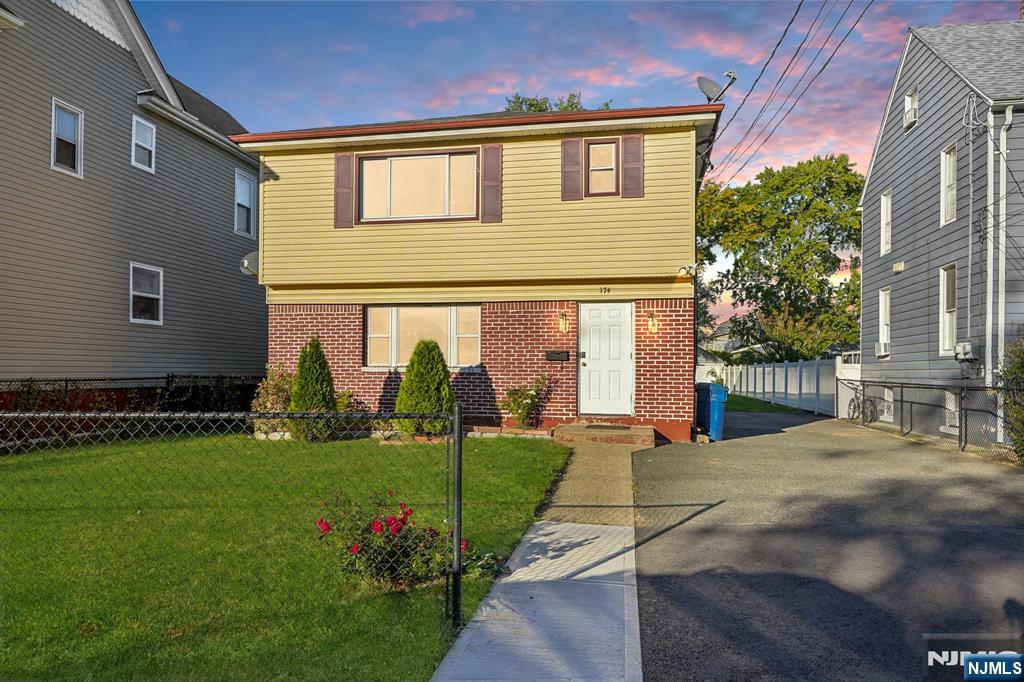 174 Clay Street Hackensack, NJ 07601 - Photo 1 of 33 a front view of a house with garden
