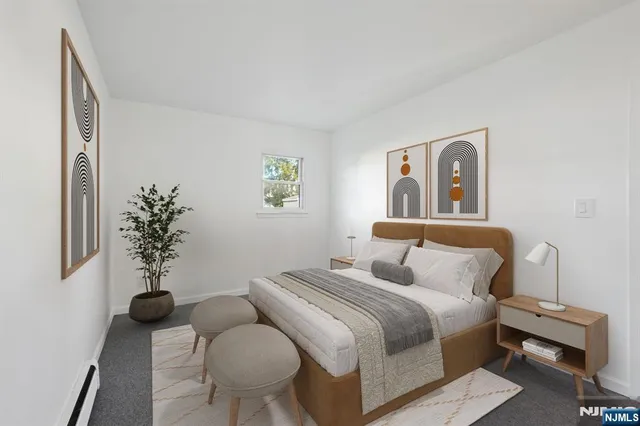 a bedroom with a bed and a painting on the wall