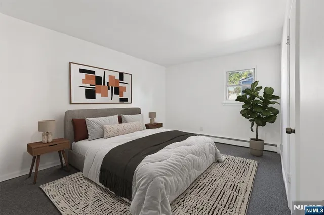 a bedroom with a bed and a potted plant