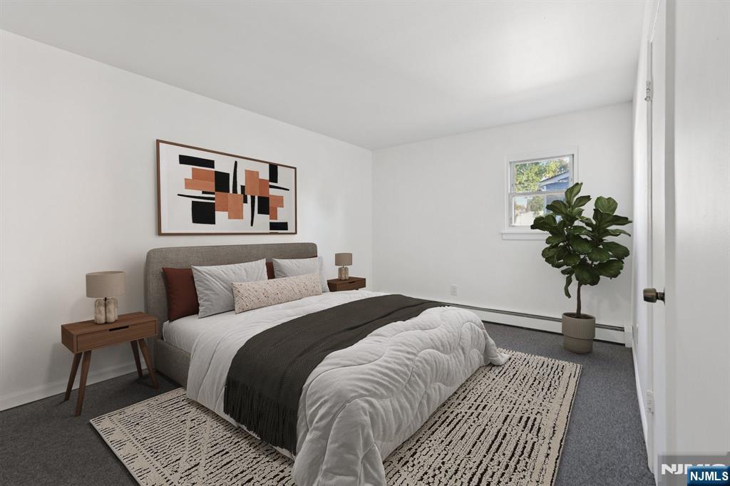 174 Clay Street Hackensack, NJ 07601 - Photo 12 of 33 a bedroom with a bed and a potted plant