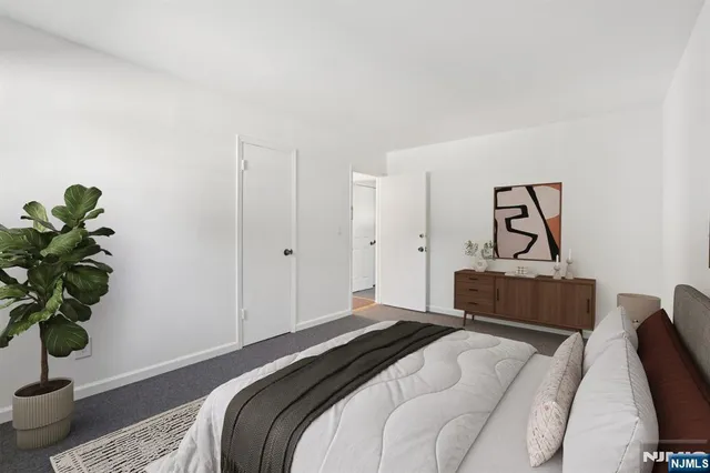 a bedroom with a bed and a potted plant