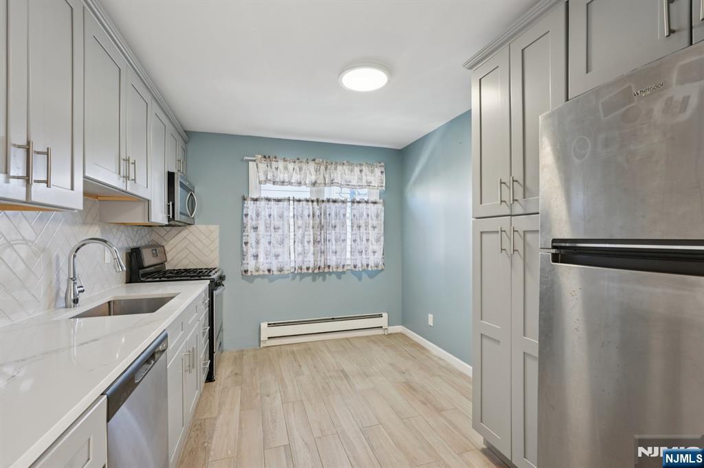 174 Clay Street Hackensack, NJ 07601 - Photo 20 of 33 a kitchen with stainless steel appliances granite countertop a refrigerator sink and cabinets