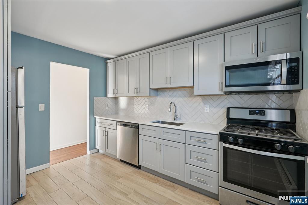 174 Clay Street Hackensack, NJ 07601 - Photo 21 of 33 a kitchen with granite countertop cabinets stainless steel appliances and a window