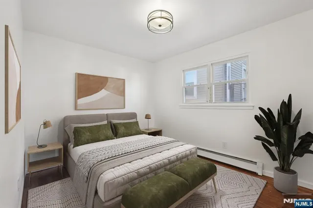 a bedroom with a bed and a potted plant