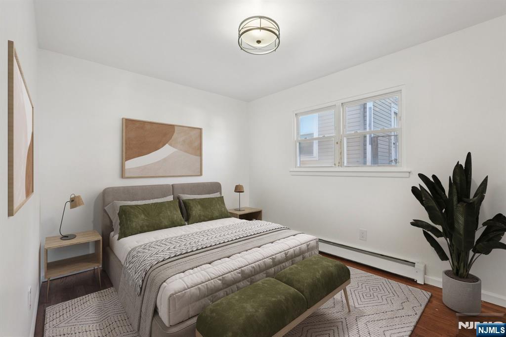 174 Clay Street Hackensack, NJ 07601 - Photo 22 of 33 a bedroom with a bed and a potted plant