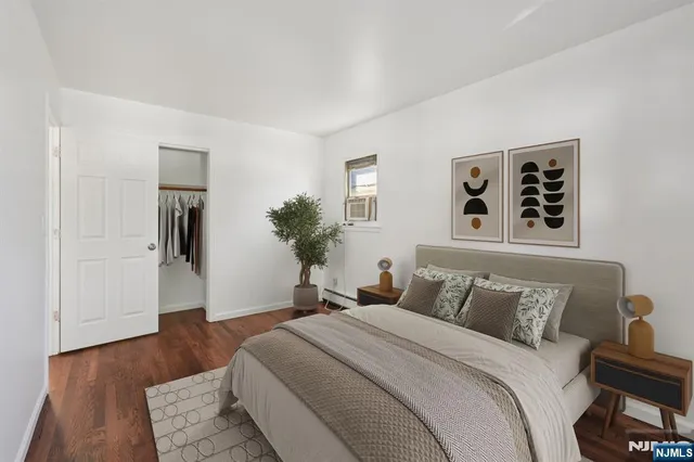 a bedroom with a large bed and a dresser