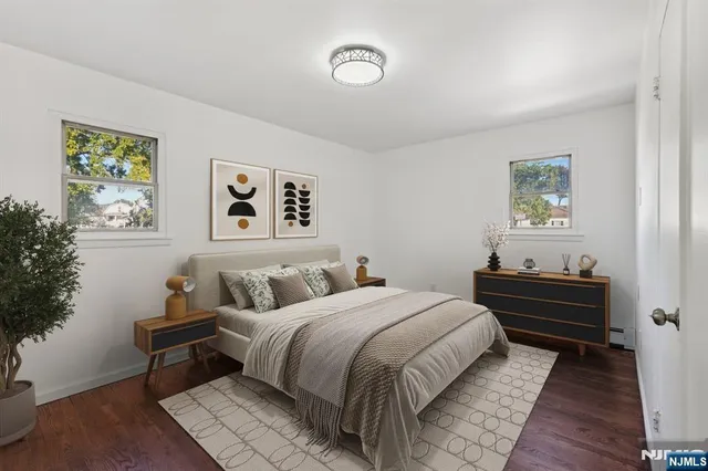 a bedroom with a bed and a lamp on the dresser