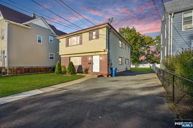a view of a house with a yard and garage