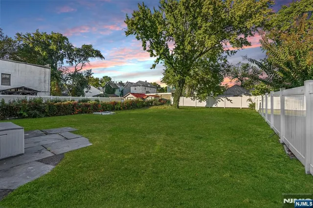 a view of yard with swimming pool and green space