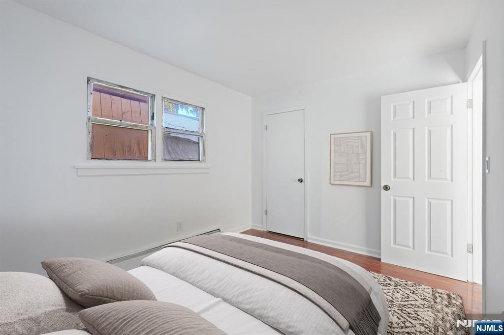 174 Clay Street Hackensack, NJ 07601 - Photo 8 of 33 a bedroom with a bed and wooden floor