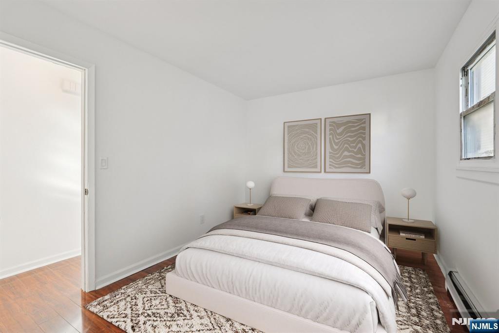 174 Clay Street Hackensack, NJ 07601 - Photo 9 of 33 a bedroom with a bed and a window