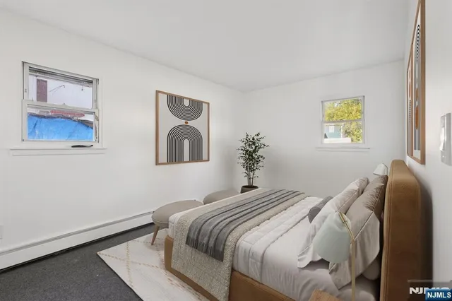 a bedroom with a bed and a painting on the wall