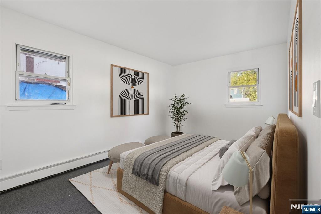 174 Clay Street Hackensack, NJ 07601 - Photo 10 of 33 a bedroom with a bed and a painting on the wall