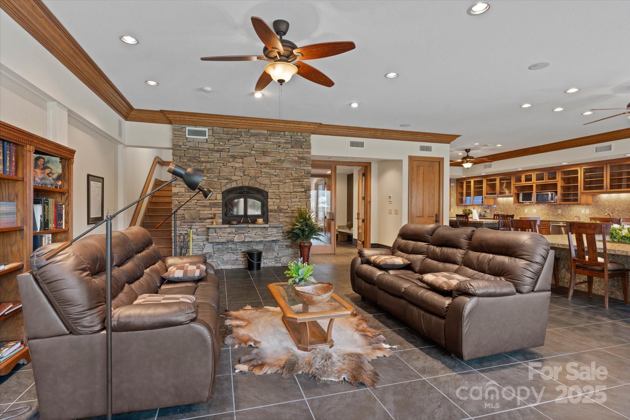 151 Pine Ridge Road Burnsville, NC 28714 - Photo 14 of 48 a living room with furniture a fireplace and a ceiling fan