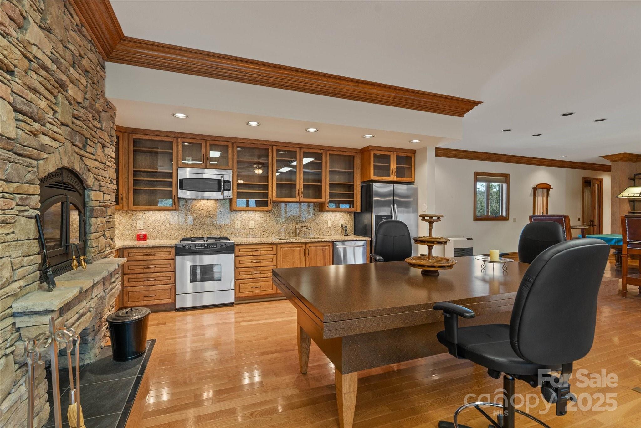 151 Pine Ridge Road Burnsville, NC 28714 - Photo 21 of 48 a large kitchen with stainless steel appliances granite countertop a stove and a dining table chair