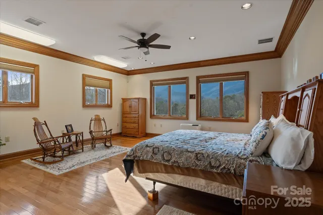 a bathroom with a granite countertop sink a toilet a large mirror and shower