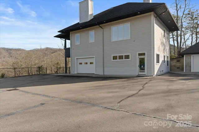 a view of a livingroom with furniture and floor to ceiling window