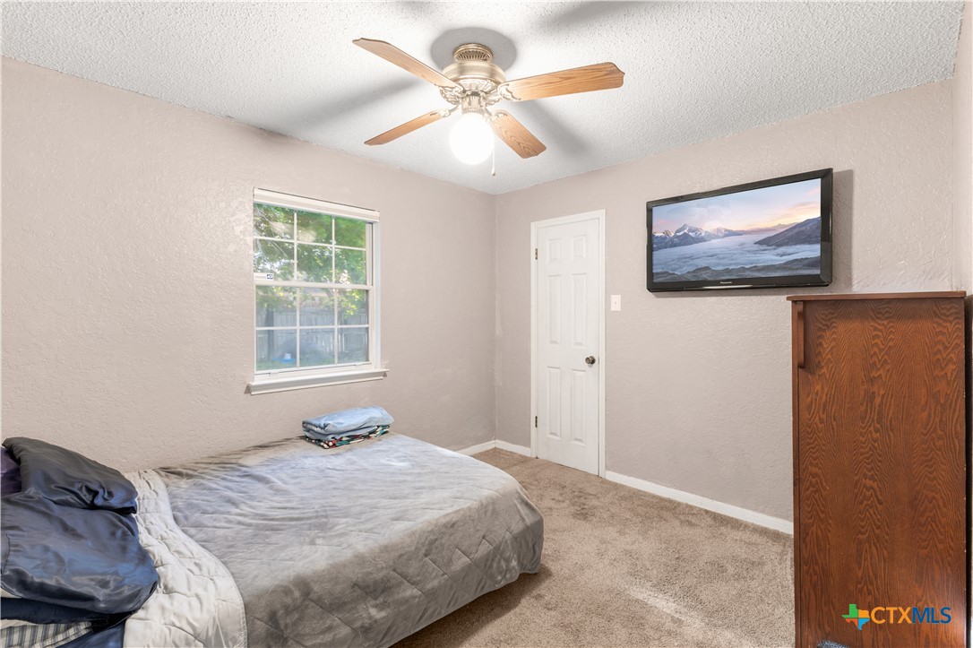 144 Jordan Loop Nolanville, TX 76559 - Photo 3 of 20 a bedroom with a bed and a painting on the wall