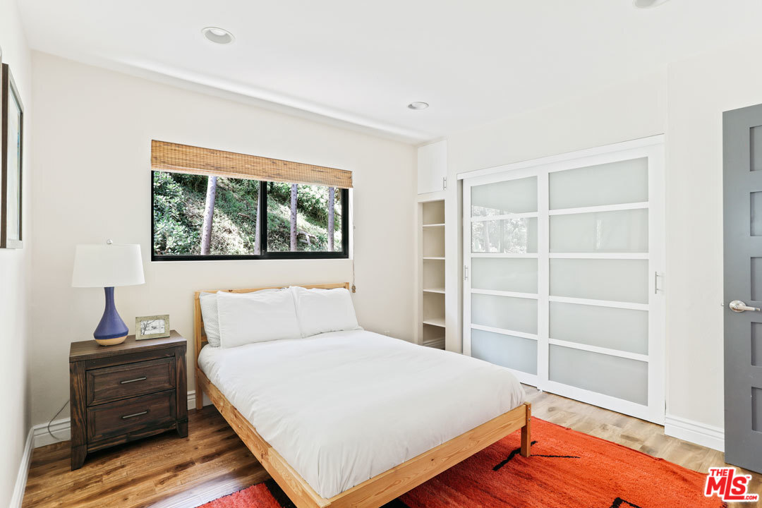 2538 Ridgeview Avenue Los Angeles, CA 90041 - Photo 15 of 31 a bedroom with a bed and wooden floor