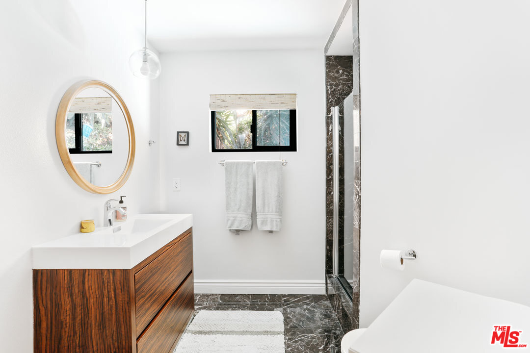 2538 Ridgeview Avenue Los Angeles, CA 90041 - Photo 16 of 31 a bathroom with a sink and a mirror