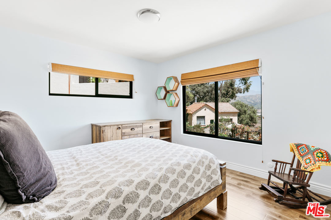 2538 Ridgeview Avenue Los Angeles, CA 90041 - Photo 17 of 31 a bedroom with a bed and a painting on the wall