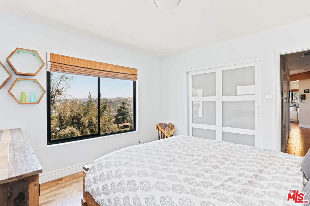 2538 Ridgeview Avenue Los Angeles, CA 90041 - Photo 18 of 31 a bedroom with a large bed and a large window