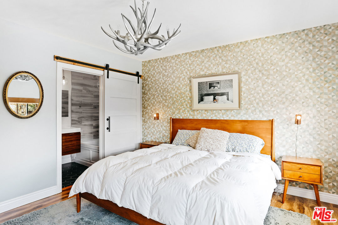 2538 Ridgeview Avenue Los Angeles, CA 90041 - Photo 24 of 31 a bedroom with a bed and a chandelier