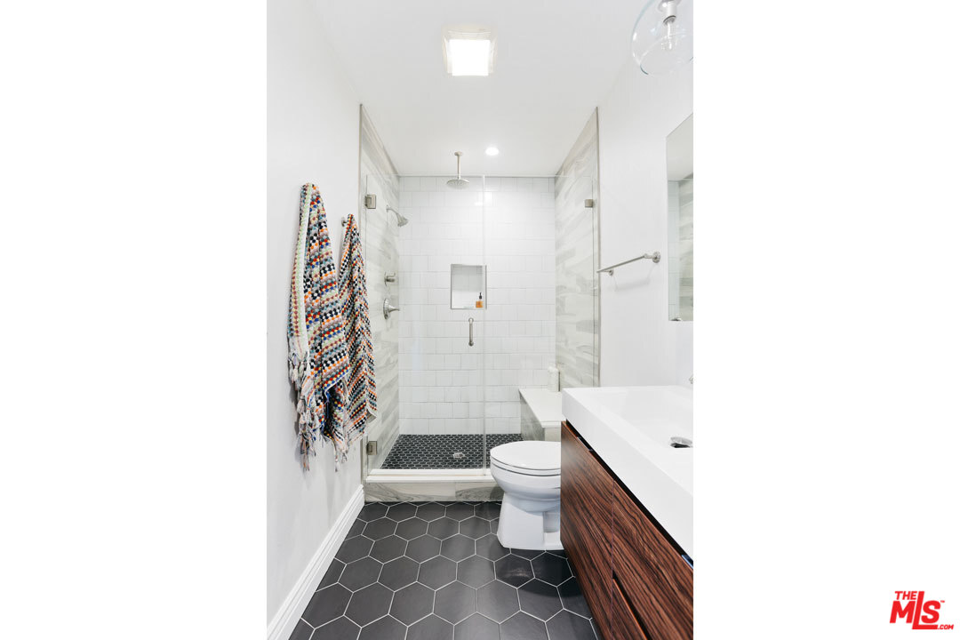 2538 Ridgeview Avenue Los Angeles, CA 90041 - Photo 27 of 31 a bathroom with a sink a toilet a shower and a mirror